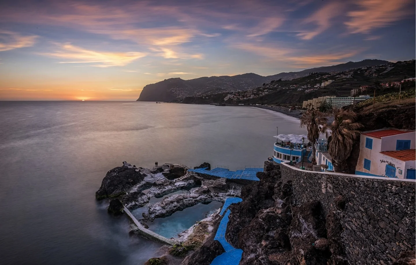 Sunset over the Atlantic with natural pools on the Madeira coastline