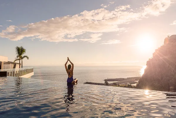 Sunset yoga by infinity pool