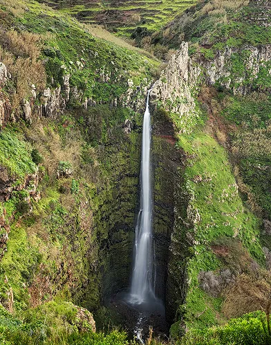 Waterfall in lush valley