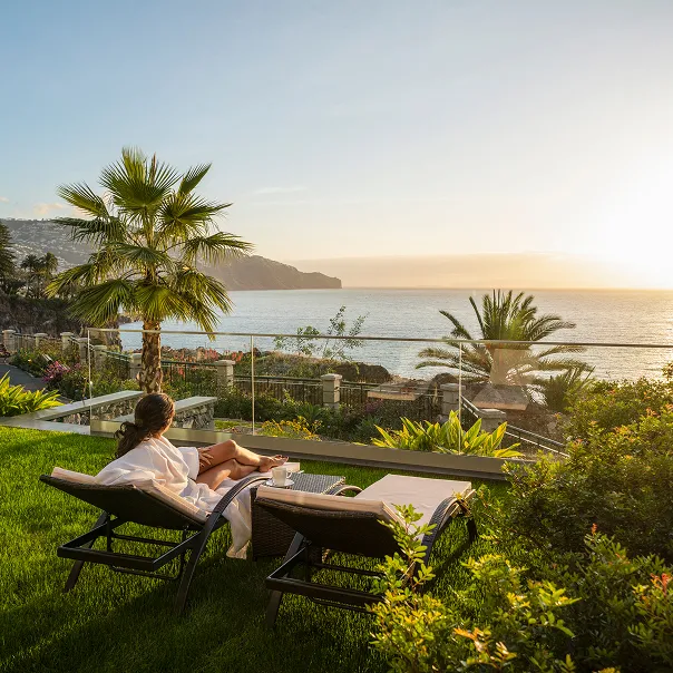 Woman relaxing with Madeira coastline view