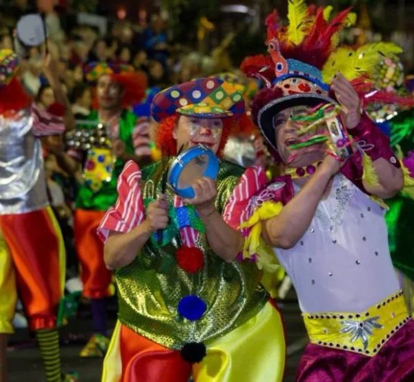 Costumed performers dancing in Funchal's Carnaval parade