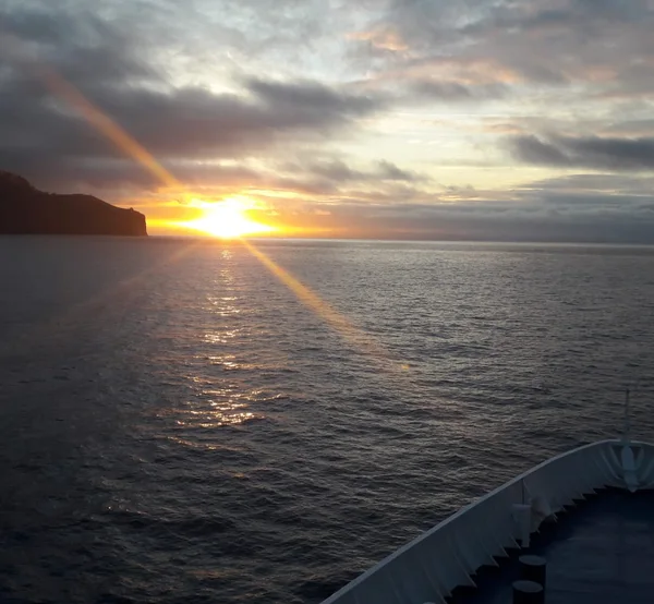 View of the ferry bow crossing the ocean at sunset