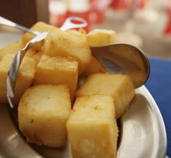 Fried cornmeal cubes, a traditional Madeiran side dish, on a plate