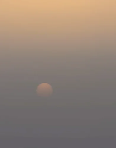 Pale, hazy sun over Madeira seen from Pico do Areeiro, dimmed by atmospheric dust
